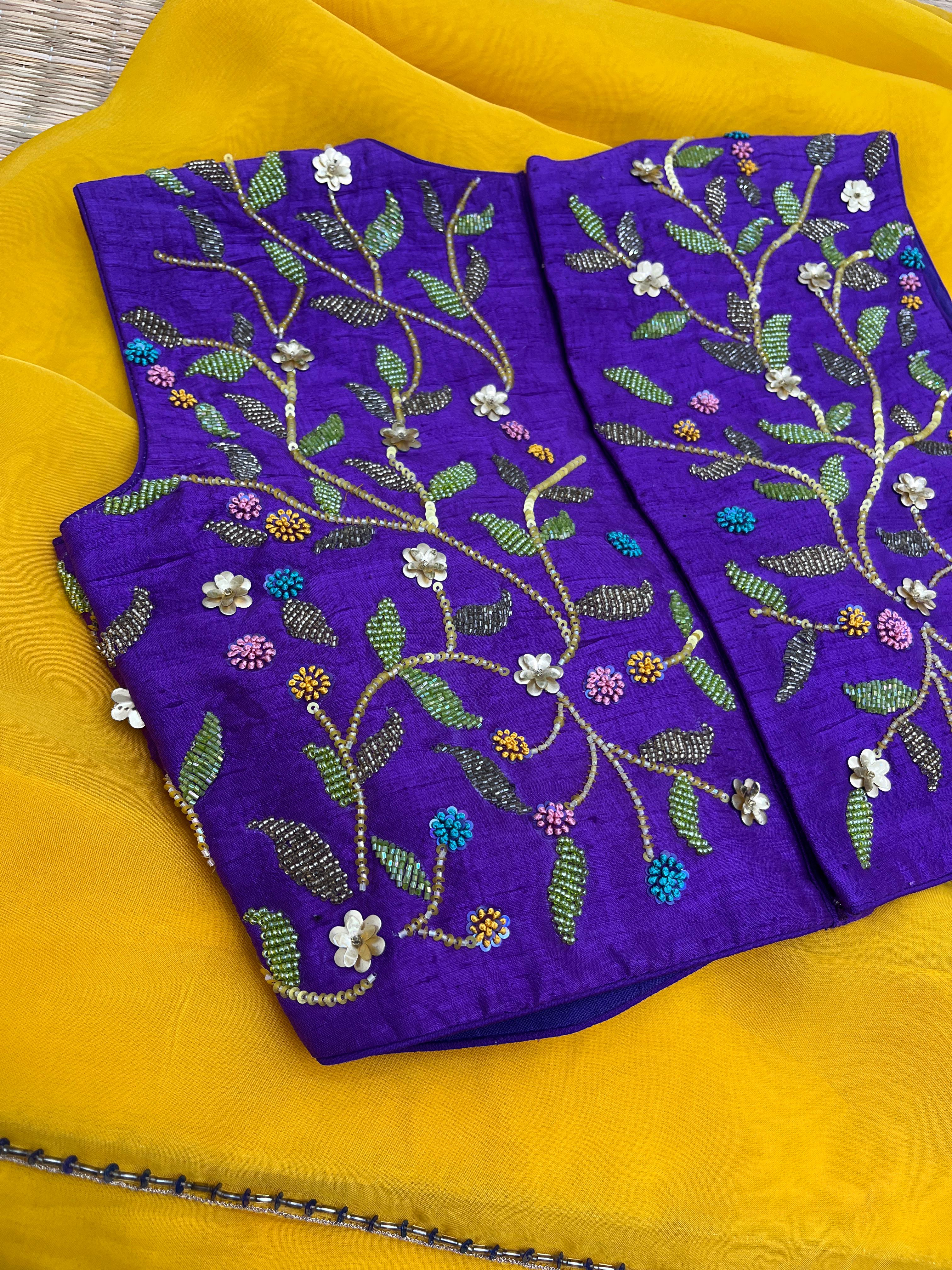 Yellow saree with Purple Blouse